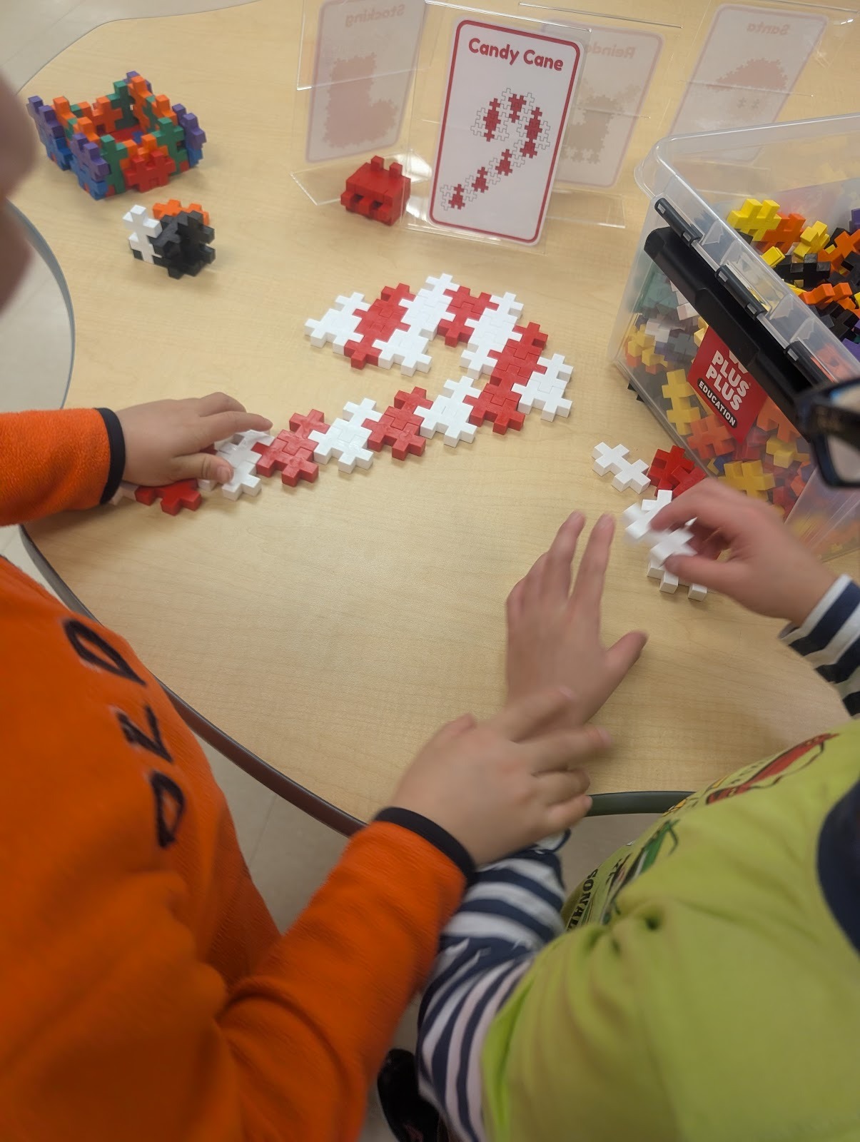 students making candy canes with plus plus blocks