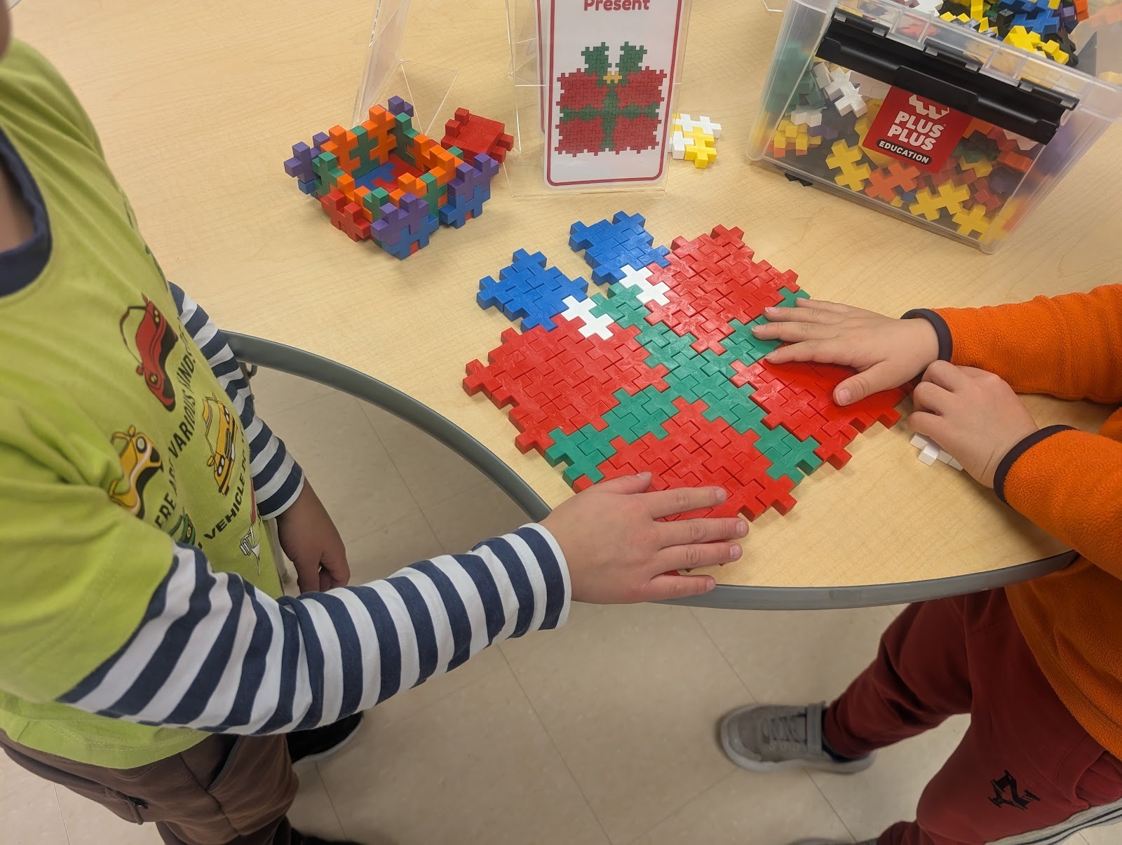 students making a present with plus plus blocks